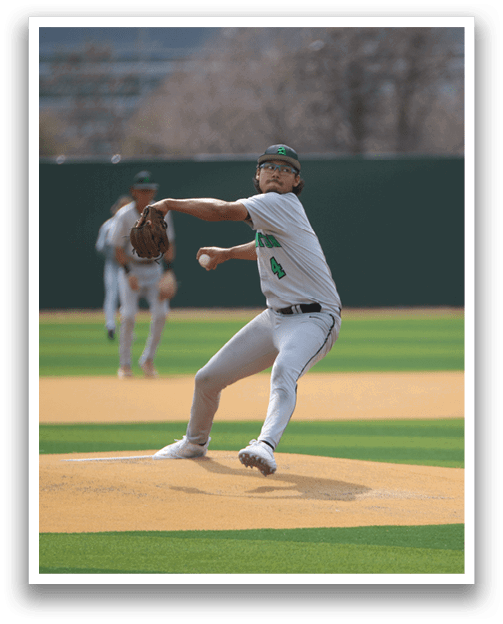 A baseball player in a white uniform is pitching a ball on a field. AI generated content
