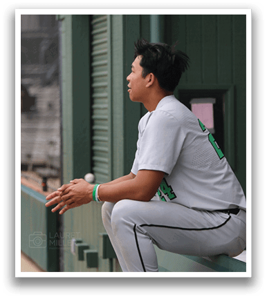 A baseball player wearing a white uniform is sitting on a bench. AI generated content