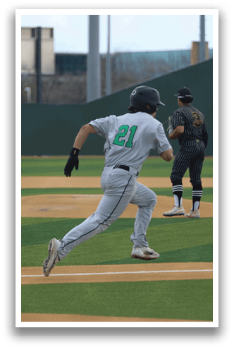 A baseball player wearing a grey uniform is running towards a base. AI generated content