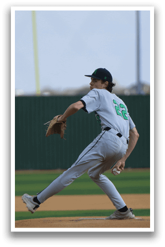 A baseball player in a green and white uniform is throwing a pitch. AI generated content