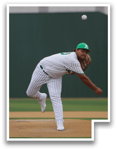 A baseball player in a white uniform is pitching a ball on a field. AI generated content