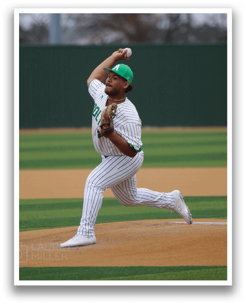 A baseball player in a green cap and white uniform is pitching a ball on a field. AI generated content