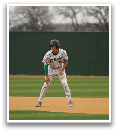 A baseball player in a green and white uniform is standing on a baseball field, holding a baseball glove. AI generated content