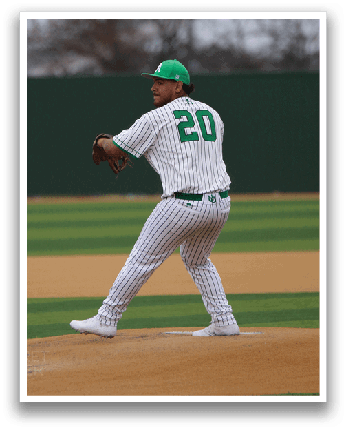 A baseball player in a green and white uniform is on the mound, preparing to throw the ball. AI generated content