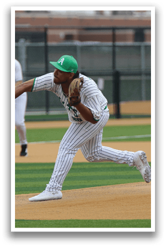 A baseball player in a green cap and white uniform is throwing a ball on a field. AI generated content