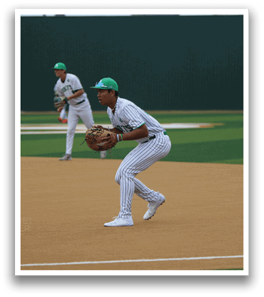 A baseball player in a white uniform is standing on a field, holding a baseball glove. AI generated content
