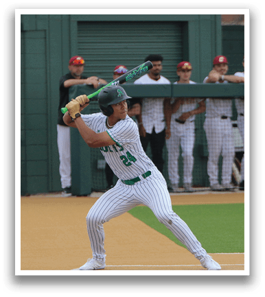 A baseball player in a white uniform is swinging a bat on a field. AI generated content
