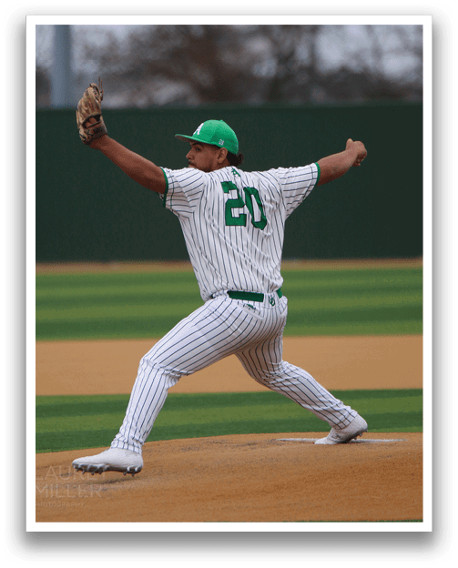 A baseball player in a green hat and white uniform is pitching a ball on a field. AI generated content
