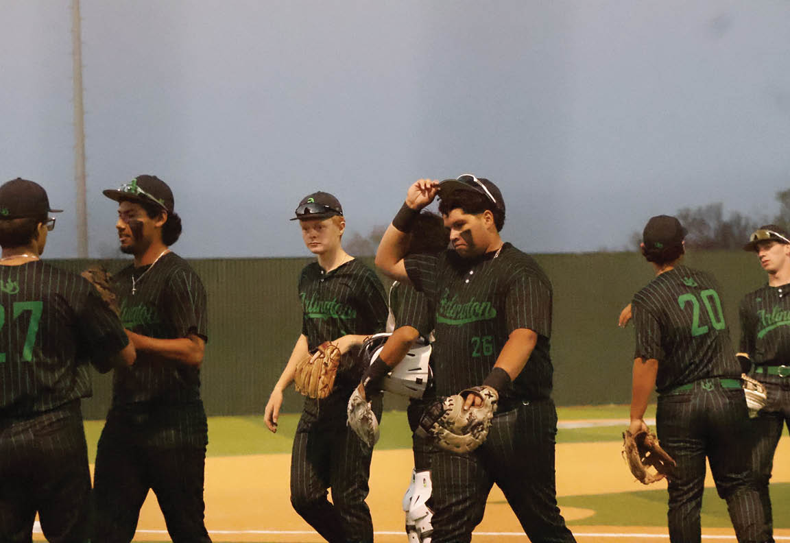 A group of baseball players wearing black and green uniforms are walking off the field. AI generated content