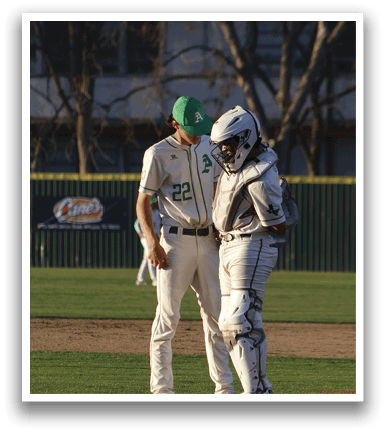 Two baseball players wearing white uniforms are standing on the field. AI generated content