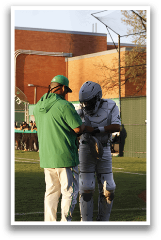 Two men are standing on a field, one of them wearing a football uniform. They are talking to each other. AI generated content