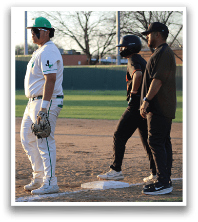 A baseball player wearing a green and white uniform stands on home plate. Another player wearing a black shirt and a helmet is standing nearby, while a third player is walking away. AI generated content