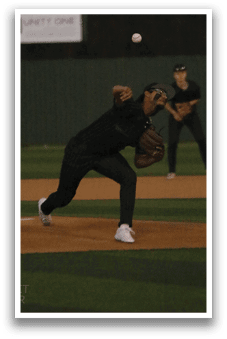 A baseball player in a green shirt is pitching a ball. AI generated content