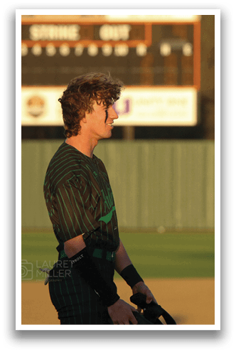 Two baseball players wearing green and black uniforms are standing on a field. AI generated content