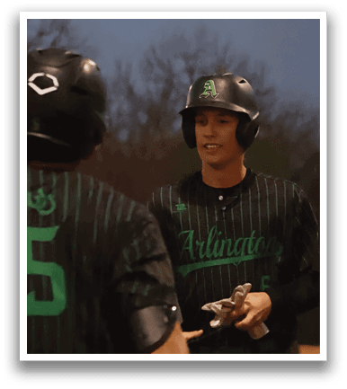 A baseball player wearing a green and white uniform is holding a bat and smiling. AI generated content