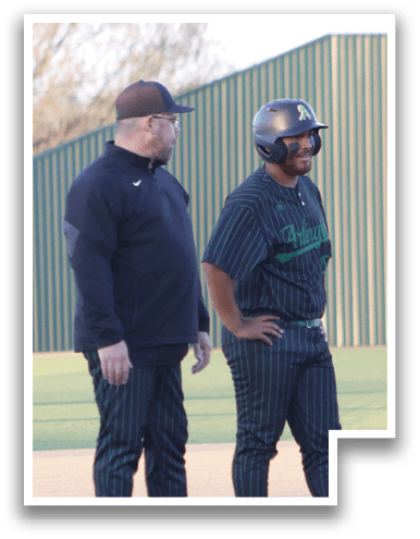 Two men are standing on a baseball field, one of them wearing a helmet. AI generated content