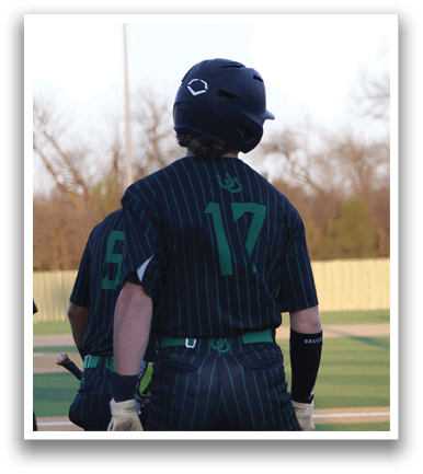 A baseball player wearing a green and black uniform is holding a bat. AI generated content