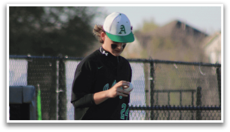 A man wearing a baseball uniform walks on a field. AI generated content