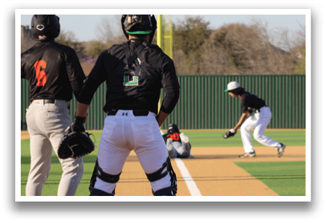 A baseball player is standing in the dirt, wearing a black shirt and a black helmet. Another player is running towards the base. AI generated content