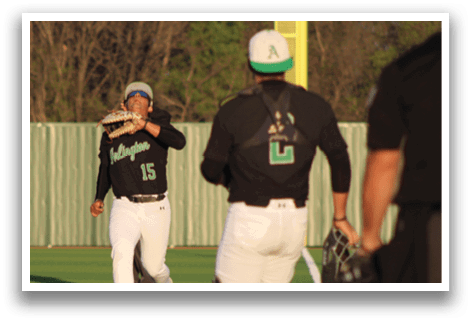 A baseball player wearing a black jersey with the number 15 on it is throwing a ball. Another player is watching the ball as it flies through the air. AI generated content