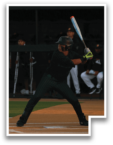 A baseball player is at bat, holding a bat and preparing to swing. AI generated content