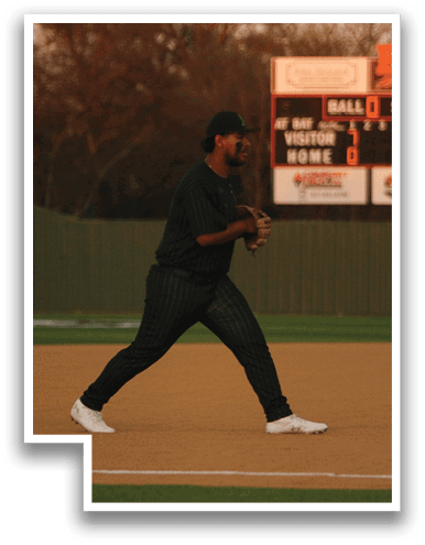 A baseball player wearing a green shirt and black pants is standing on the field, holding a baseball glove. AI generated content