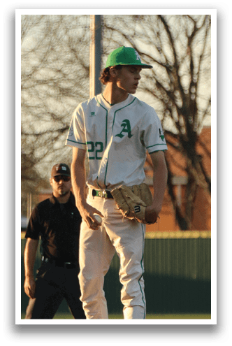 A baseball player stands on the pitcher's mound, wearing a green hat and a white uniform. AI generated content