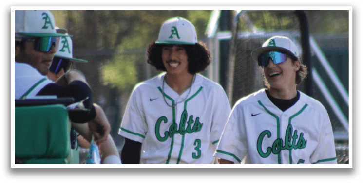 Two baseball players wearing white uniforms and green caps are walking on the field. AI generated content