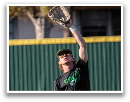 A baseball player wearing a black and white uniform is reaching up to catch a ball. AI generated content