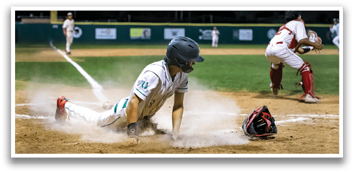 A baseball player wearing a green and white uniform is walking on the field. AI generated content
