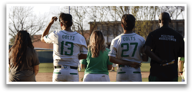 Four people wearing green and white uniforms pose for a picture on a baseball field. AI generated content