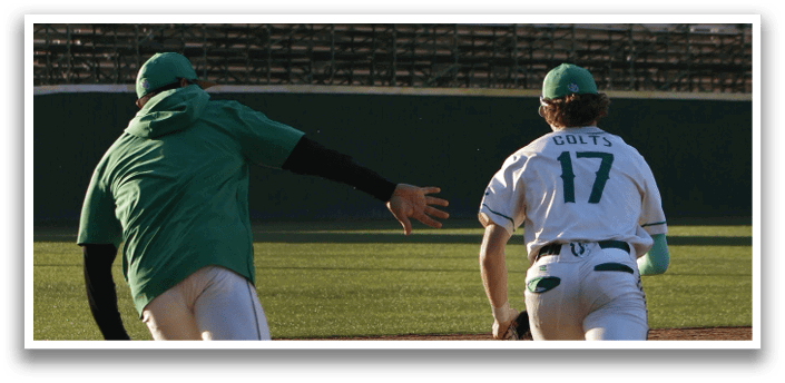 Two baseball players running on a field, one wearing a green shirt and the other wearing a white shirt. AI generated content
