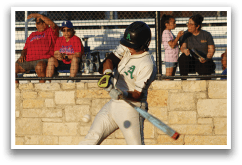 A baseball player is swinging a bat, and a ball is in the air. A group of people is watching the game from the stands. AI generated content