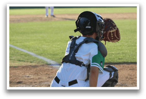 A baseball player is squatting on the field, wearing a catcher's mitt and a helmet. AI generated content
