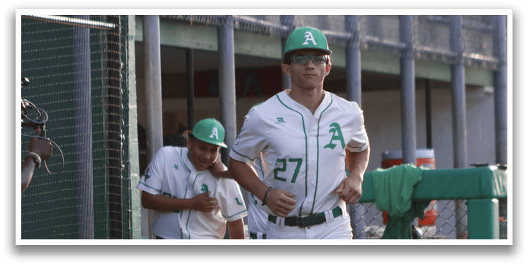 A baseball player wearing a green and white uniform. Description generated by AI