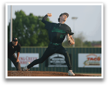A man in a black and green shirt is throwing a baseball. Description generated by AI