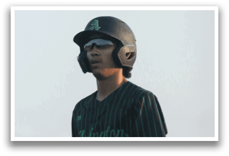A baseball player holding a bat. Description generated by AI