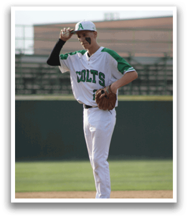 A baseball player wearing a white jersey with the word Colts on it. Description generated by AI