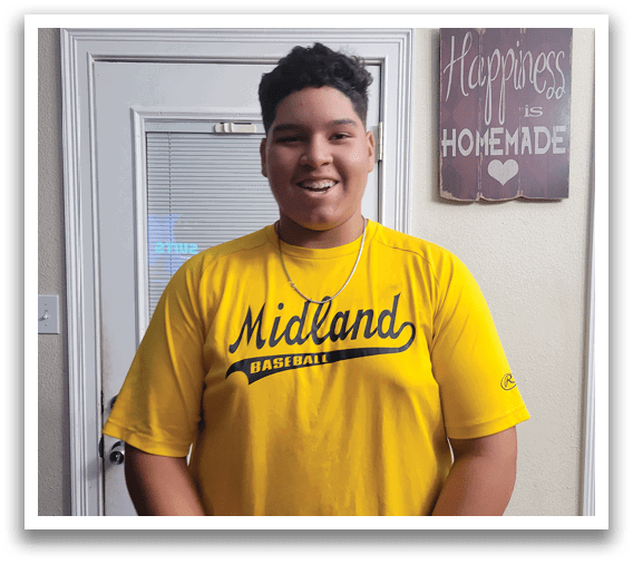 A man wearing a yellow shirt with the word Midland on it. Description generated by AI
