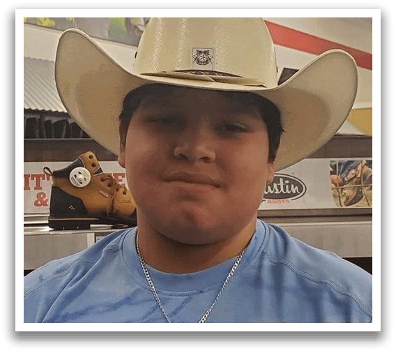 A man wearing a cowboy hat and a blue shirt. Description generated by AI