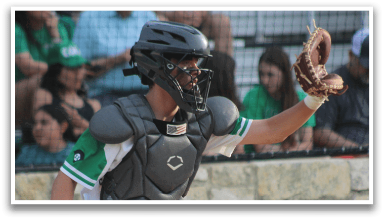 A baseball player wearing a helmet and catcher's gear. Description generated by AI