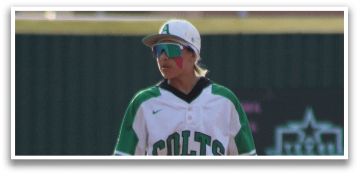 A baseball player wearing a green and white shirt and holding a baseball glove. Description generated by AI