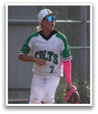 A boy wearing a white jersey with the word Colts on it. Description generated by AI