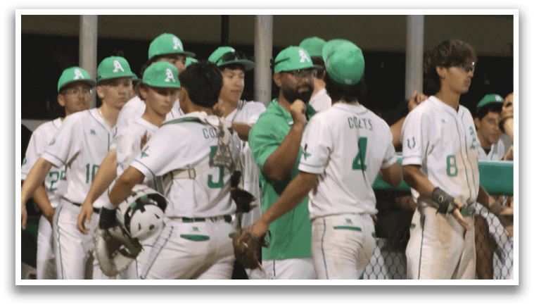 A group of baseball players wearing green and white uniforms. Description generated by AI