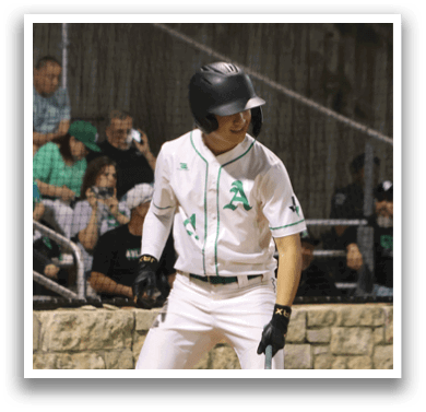 A baseball player in a white uniform is swinging a bat. Description generated by AI