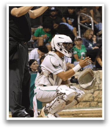 A baseball catcher wearing a white uniform. Description generated by AI