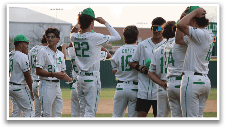 A group of baseball players wearing green and white uniforms. Description generated by AI