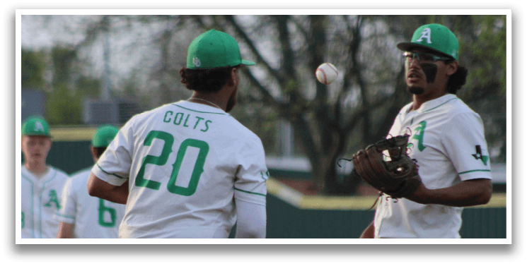 Two baseball players standing on a field. Description generated by AI