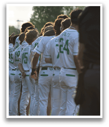 A group of baseball players wearing white uniforms. Description generated by AI