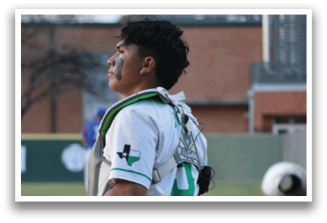 A baseball player wearing a white uniform with a green stripe and the number 16. Description generated by AI
